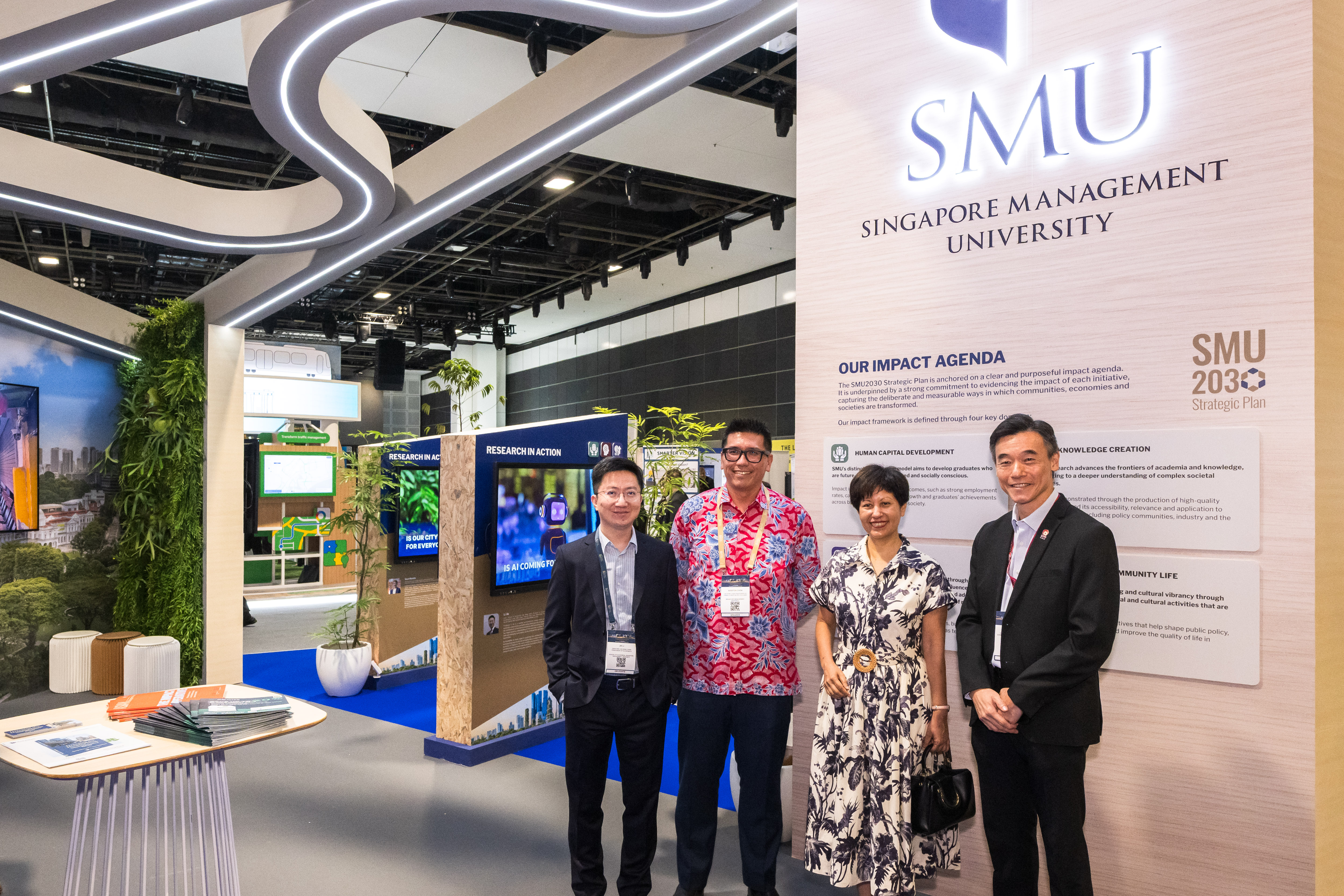 (L-R) Prof Li Jia, Prof Winston Chow, Minister Indranee Rajah, Christopher Chew (VP, Corporate Communications & Marketing) at the SMU exhibition booth at WCS 2026.