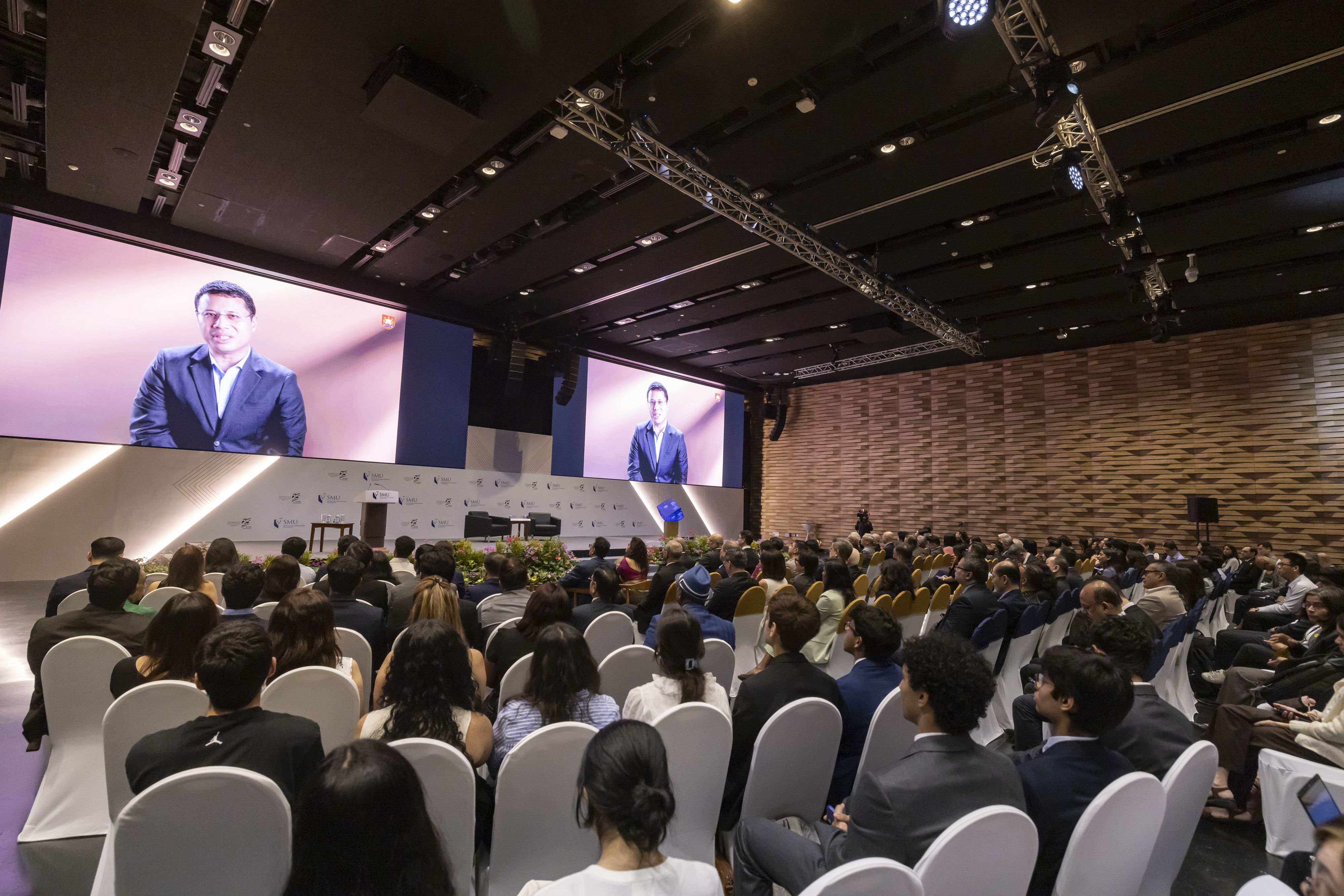 Minister Desmond Lee addressing the audience through a pre-recorded message.