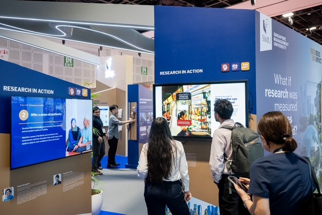 Delegates engaging with SMU staff and faculty at the SMU booth