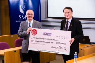 Mr Ho Siong Hin, Chairman of the Char Yong (Dabu) Foundation, handing the gift to SMU President, Professor Arnoud De Meyer.