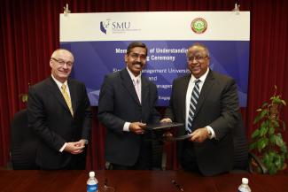 Professor Rajendra K Srivastava (R), and Professor R Rameshan (Centre), exchange signed MOUs, witnessed by Professor Arnoud De Meyer (L).