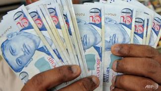 File photo of Singapore dollars. (File photo: AFP/Roslan Rahman)