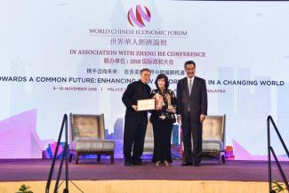 Dr Noeleen Heyzer receiving her award on stage with Tan Sri Lee Kim Yew Co-Founder and Patron, World Chinese Economic Forum (Left) and The Hon. CY Leung Vice Chairman, National Committee of the Chinese People's Political Consultative Conference (Right)
