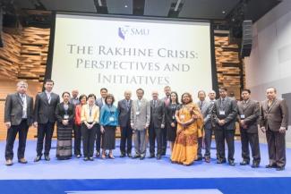 Speakers and panelists gathered on stage for a group photo at the start of the Rakhine Crisis symposium held at the SMU Hall on 7 May 2018.