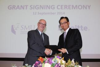 Signatories at the Research Grant Signing Ceremony held on 12 September 2014 – SMU President, Professor Arnoud De Meyer, and Mr Tam Chee Chong, Regional Managing Partner of Financial Advisory Services at Deloitte Southeast Asia.