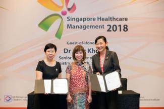 MOU signing between Prof Lily Kong, Provost, SMU (left) and Prof Ivy Ng, Group CEO, SingHealth (right), witnessed by Dr Amy Khor, Senior Minister of State for Health.