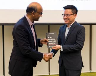 DPM Tharman receiving the book from Professor David Chan