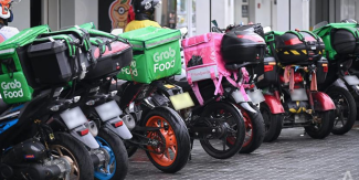 Food delivery riders' motorbikes parked outside Century Square while they pick up lunch orders on Monday (May 17), the second day of Phase 2 (Heightened Alert) where dining in food-and-beverage (F&B) establishments are not allowed. (Photo: Gaya Chandramohan)