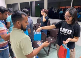 Mas, leader of Project Candela 3, engaging migrant workers with games and prizes – building bonds across communities.