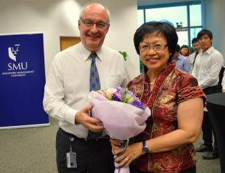 SMU President, Professor Arnoud De Meyer presenting a bouquet to Mrs Jane Tan, wife of the late Professor Tan Teck Meng at the “Tan Teck Meng Memorial Fund” Donor Appreciation Tea.